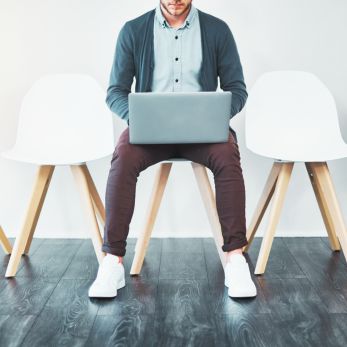 Man in waiting room with laptop