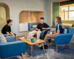 Students sitting on couches talking and drinking coffee