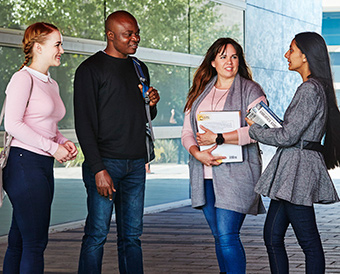 Four students chatting on campus