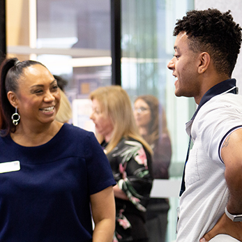 students discussing career opportunities over a library able 