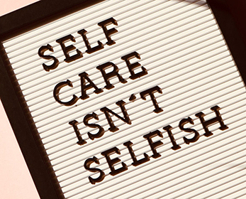 signreading 'self care isn't selfish' 