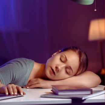 Student Sleeping on top of books