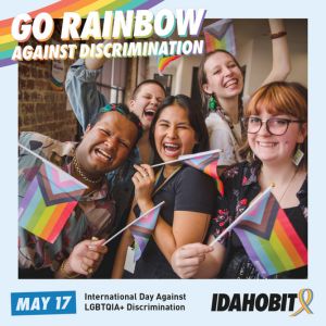 Five people smiling holding pride flags. The border around the image says 'GO RAINBOW AGAINST DISCRIMINATION'