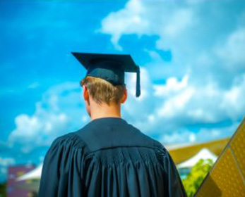student facing away from camera in graduation regalia